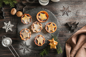 Composition with tasty mince pies on wooden background