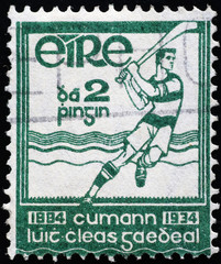 Field hockey player on ancient irish postage stamp