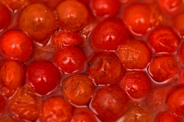 The cranberry is red in water in a glass