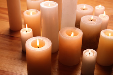 Fototapeta na wymiar Burning candles on wooden table