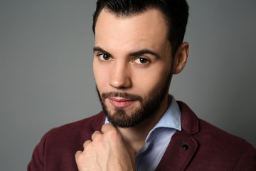Fototapeta premium Fashionable young man on grey background
