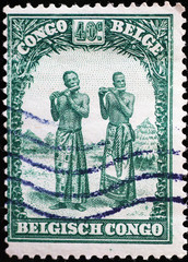 Two men playing instruments on ancient african stamp