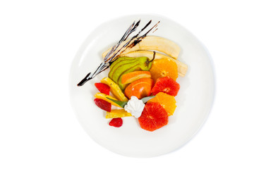 Fresh fruits salad on plate isolated on white