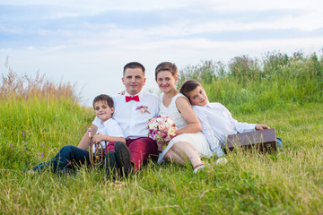 Romantic family in the field at evening glow