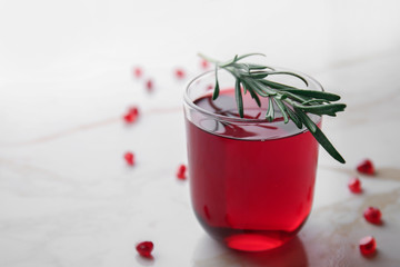 Glass of tasty pomegranate juice on table