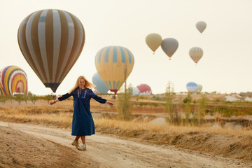 Woman Having Fun With Flying Hot Air Balloons On Background