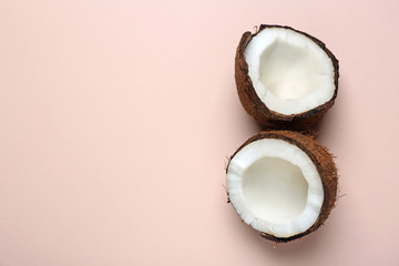 Cut ripe coconut on color background