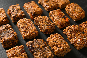 Tasty granola bars on dark background