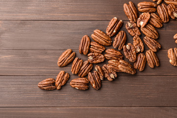 Pecan nuts on wooden background
