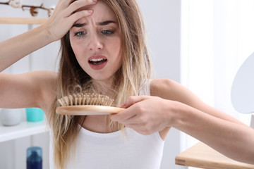 Woman with hair loss problem at home