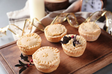 Tasty mince pies on wooden board