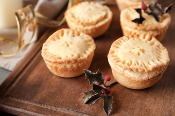 Tasty mince pies on wooden board