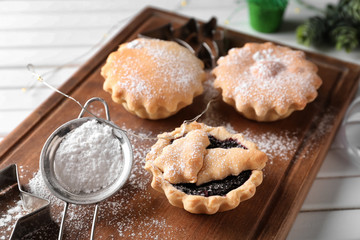 Tasty mince pies on wooden board