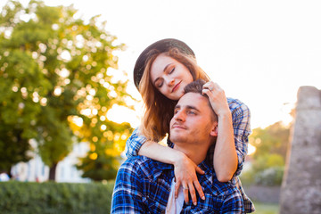 Fototapeta premium Young couple sitting on a stone wall