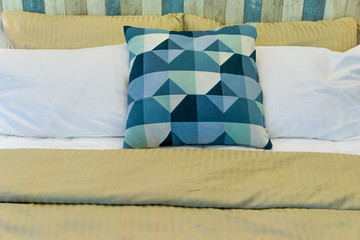 Modern white fabric pillows and checkered pattern on the bed interior decoration