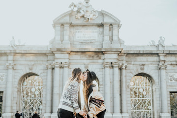 Fototapeta na wymiar Couple women kissing on the street in Madrid city