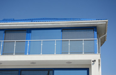 Modern blue house with glass balcony. Contemporary house disign.