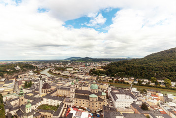 Fototapeta na wymiar Salzburg city panorama with old town and Salzach river with great clouds above.