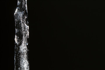 Obraz na płótnie Canvas Icicle on black background