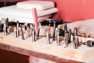 Various drills set inserted into a piece of wood