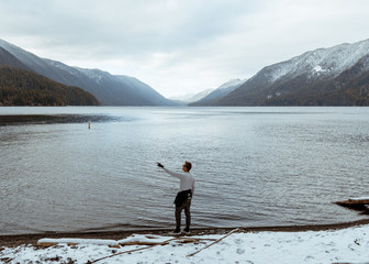 man on the lake pointing  