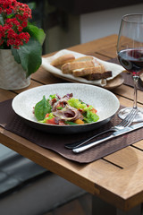 Hearty salad with fresh lattice, beef, crispy fried onions and eggs. Served with mayonnaise. Top view.