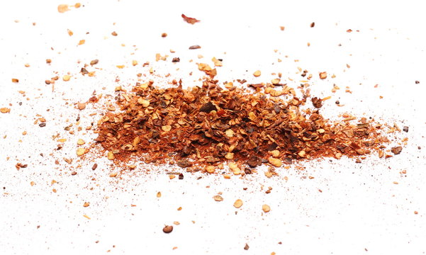 Crushed, ground red cayenne pepper, spicy chopped paprika isolated on white background