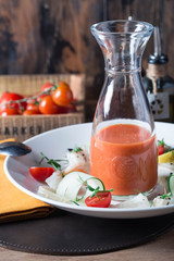 Gazpacho gaspacho spanish traditional vegetable tomato soup in glass bowl with vegetables on old wooden table. Served by chef