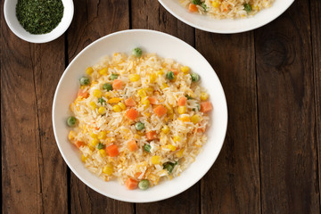 Fried rice in white plate on wood