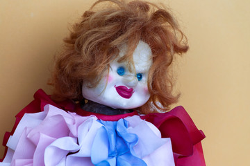 Creepy clown doll in colorful clothes