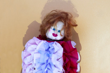 Creepy clown doll in colorful clothes