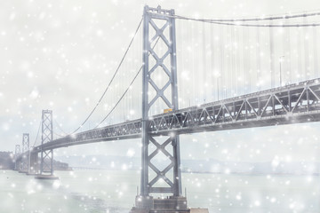 The view on the Bay Bridge and Treasure Island from San Francisco in the snowfall.