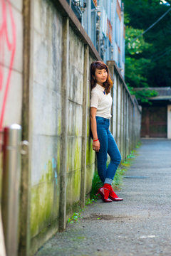 Asian female model poses for pictures on the street