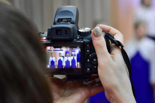 May 12, 2018. Krasnoyarsk. Russia. A woman shoots her child's performance at a concert on the camera fujifilm finepix hs 35. Video will be remembered for her daughter