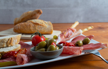 Italian antipasto on a white dish