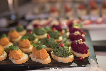 Beautifully decorated catering banquet table with different food snacks and appetizers on corporate christmas birthday party event or wedding celebration