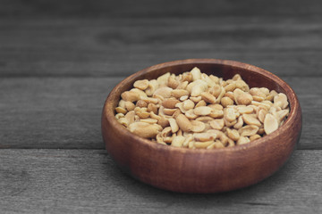 Peanuts on grey wooden table