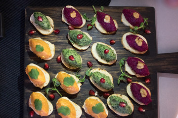 Beautifully decorated catering banquet table with different food snacks and appetizers on corporate christmas birthday party event or wedding celebration
