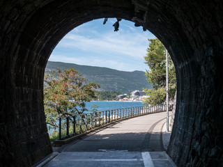 Old stone brick tunnel with summer beach view on the other side