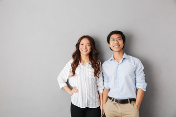 Cheerful asian business couple standing