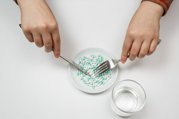 Supplementary food on the dish with fork and spoon