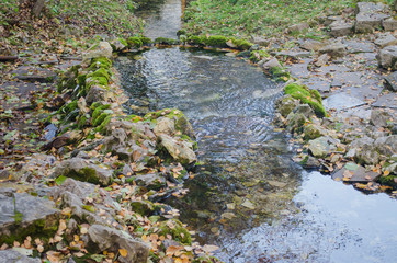 Source of drinking water, surrounded by old stones.