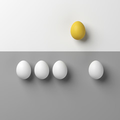 Notable yellow egg with white eggs on white and grey background.minimal style