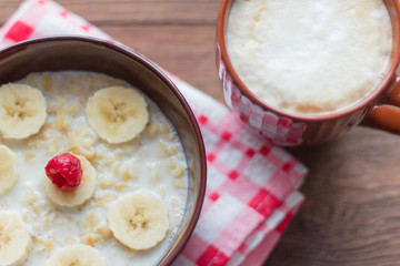 healthy Breakfast, oatmeal with fruit and coffee with foam