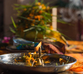 Plate with lit diya after the puja at Shri Ganesh.