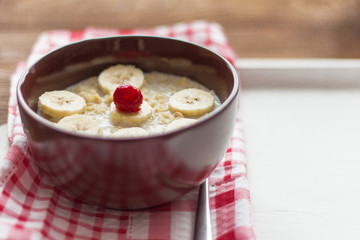 delicious hot oatmeal with fruit and berries on wooden background, healthy Breakfast