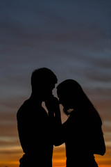 Silhouettes of a loving couple at sunset