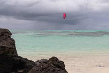 kitesurfer surfing in front of storm front