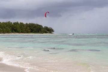 kitesurfer surfing in front of storm front
