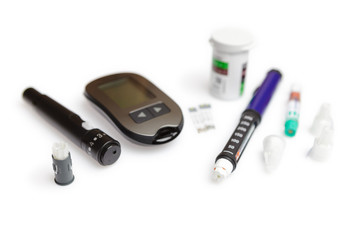 Diabetic set of lancet with spare needles, glucometer, strips, box of spare strips, pen injector, spare insulin and pen needles isolated on white background